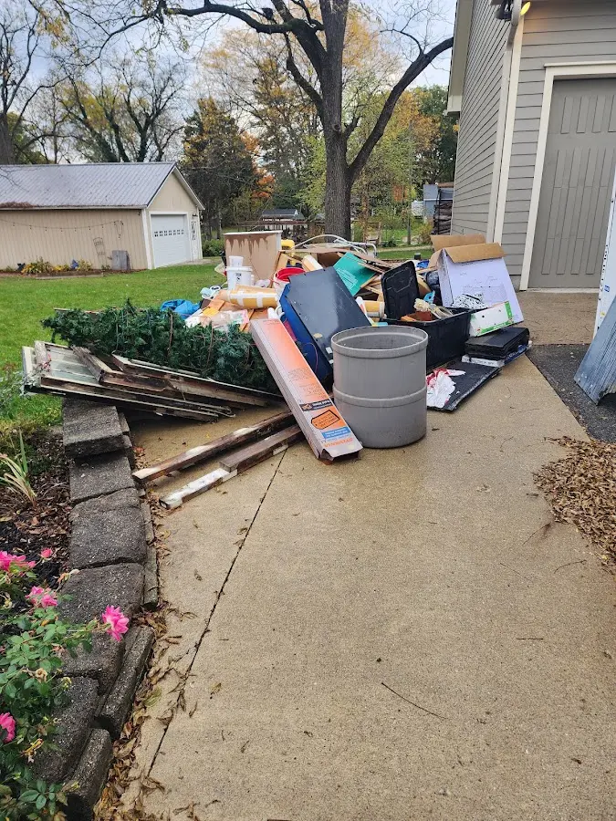 Dumpster being loaded with debris for 12 Yard Dumpster Rental in Park Hills